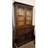 An Edward VII carved walnut secretaire bookcase