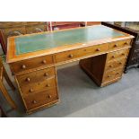 A Victorian mahogany and green leather topped pedestal desk