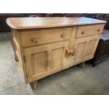 An Ercol Blonde elm and beech sideboard