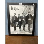 A black and white Beatles print, framed