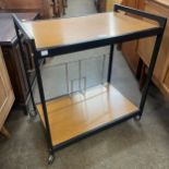 A Howard Miller style black metal and Formica cocktail trolley