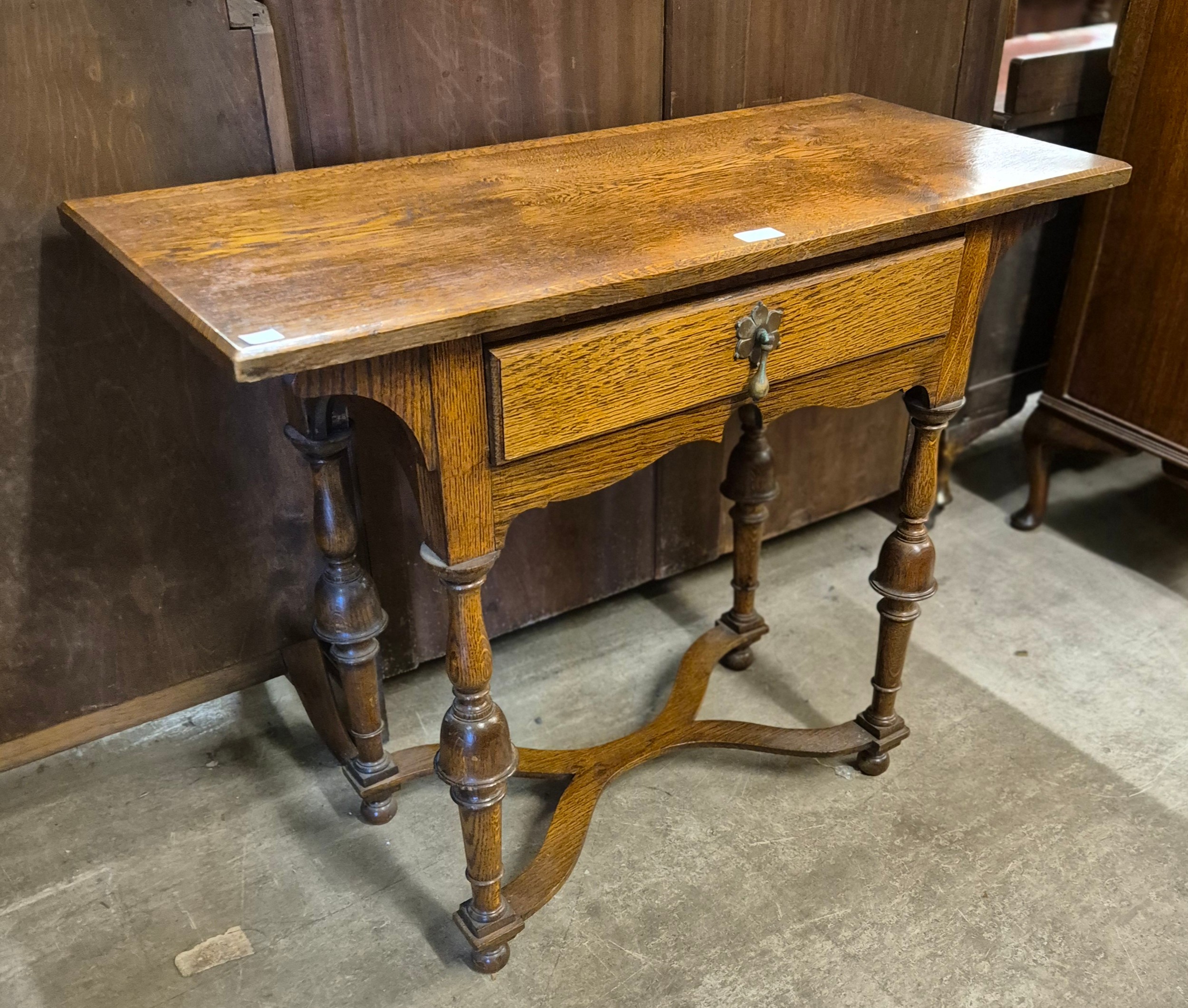 A George I style oak single drawer side table