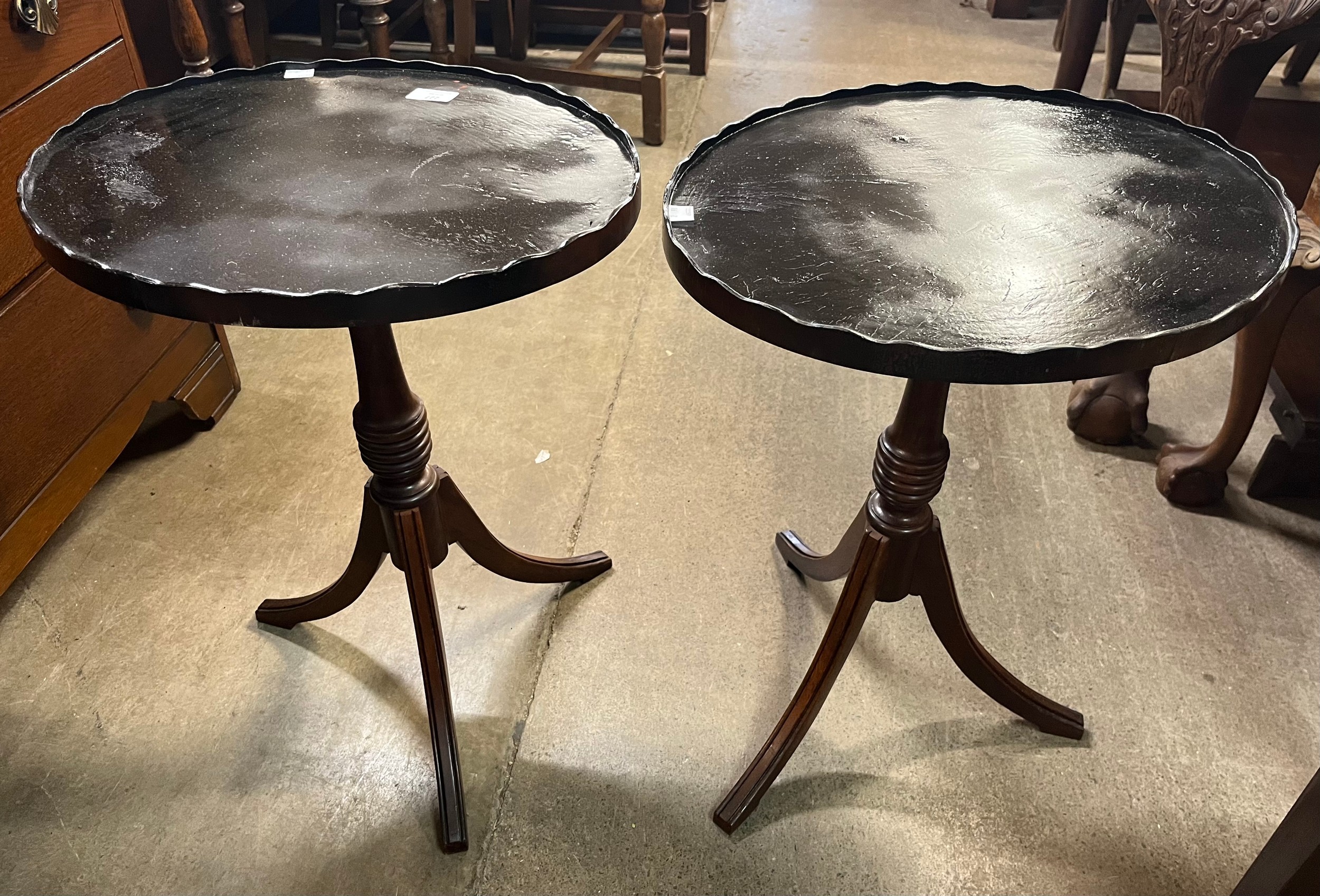 A pair of mahogany tripod wine tables