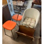 A wicker chair, two metal chairs and a magazine rack