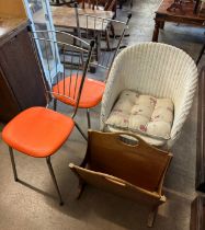 A wicker chair, two metal chairs and a magazine rack