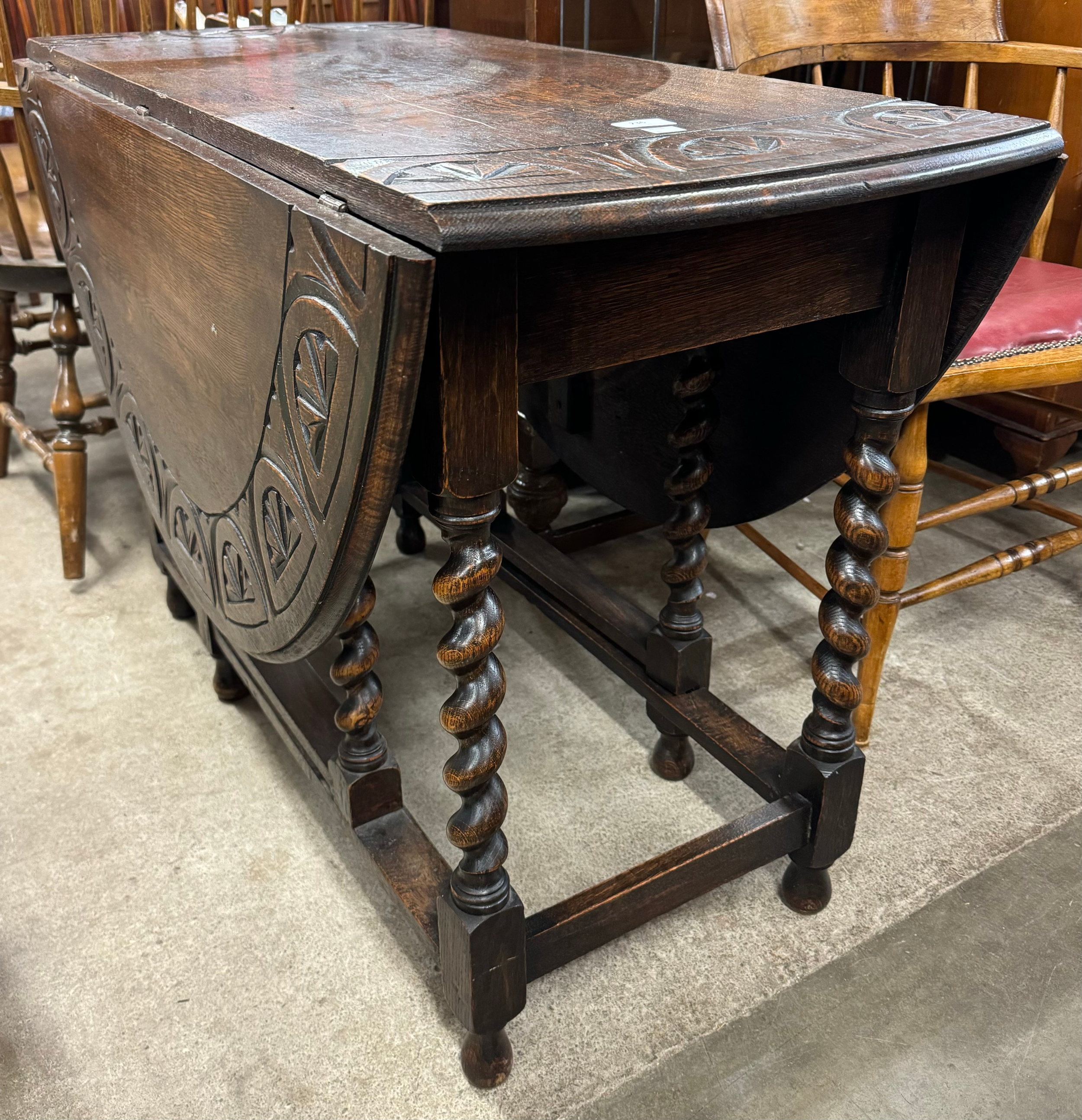 An early 20th Century carved oak gateleg table