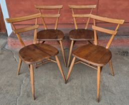 A set of four Ercol Blonde elm and beech green dot stacking chairs