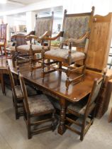 A 17th Century style carved oak refectory table and six chairs