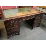 A George III style mahogany and green leather topped pedestal desk