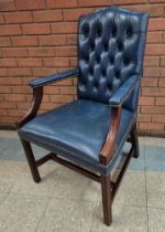 A mahogany and blue leather Gainsborough style chair