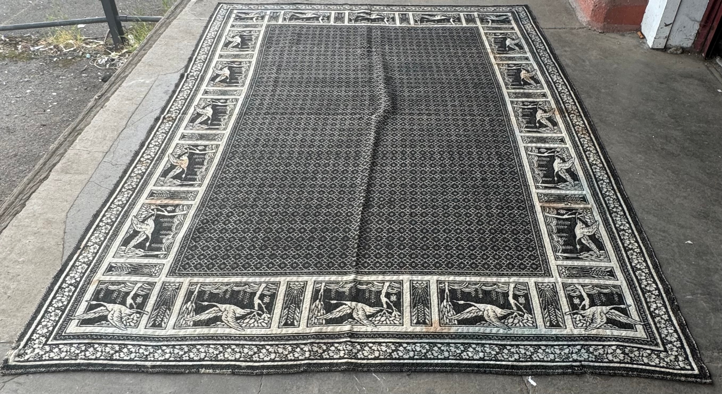 An Arts and Crafts style grey ground rug