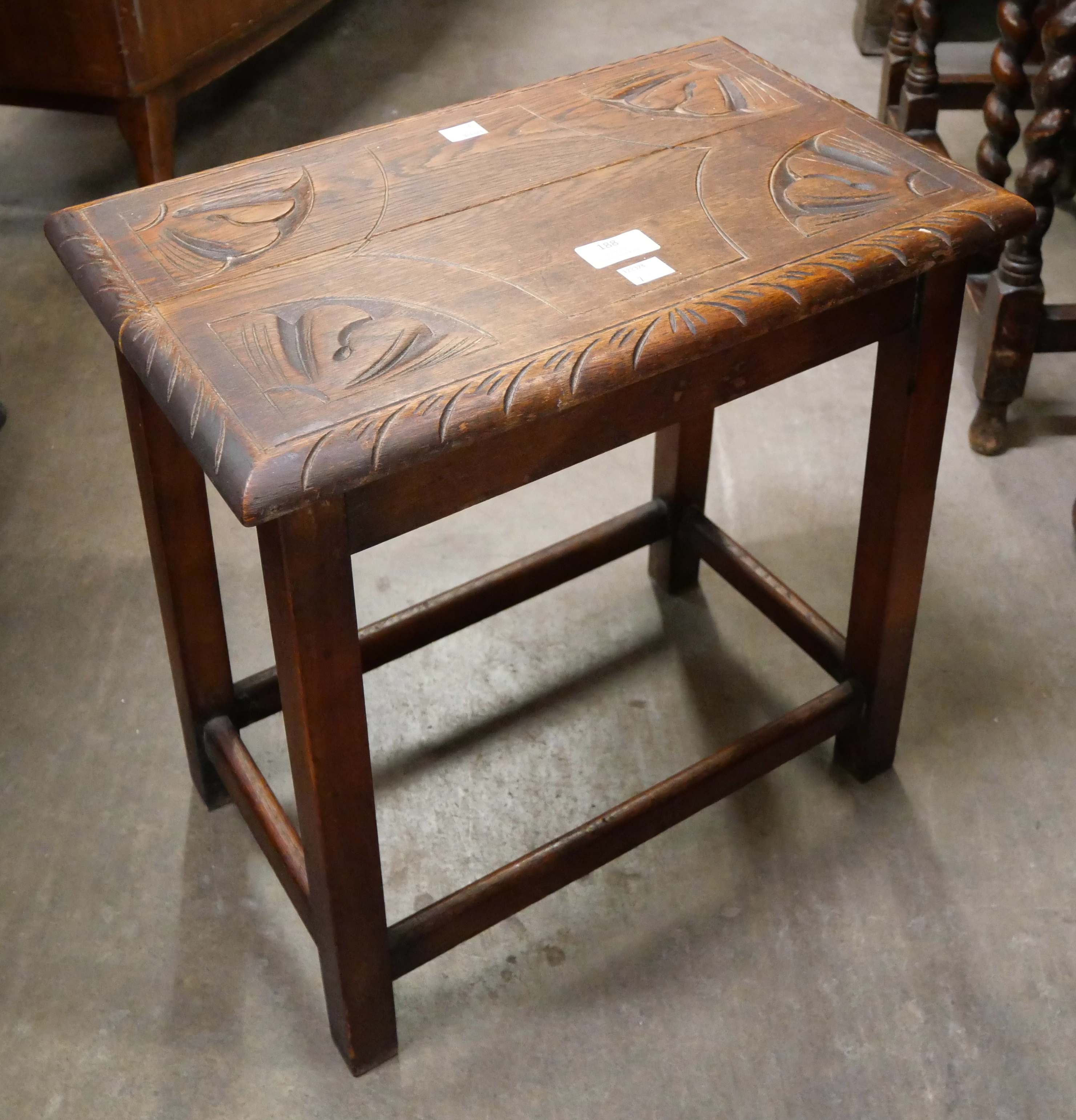 An early 20th Century carved oak stool