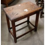 An early 20th Century carved oak stool