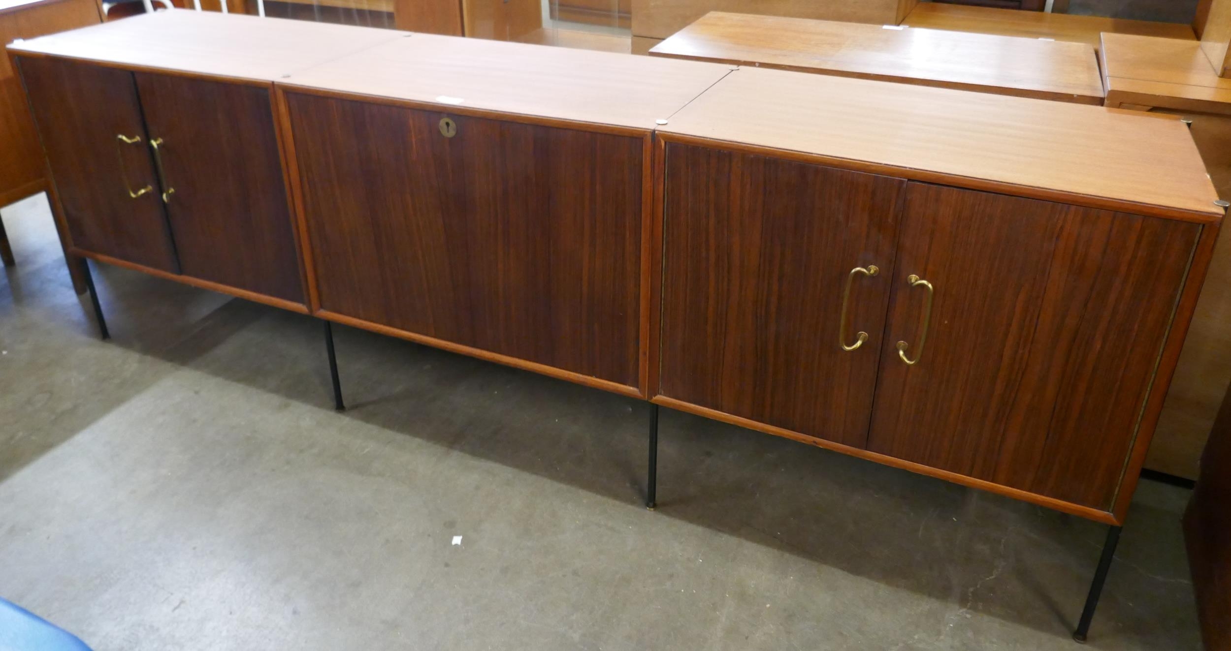 A fitted tola wood sideboard