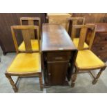 An oak drop-leaf table and four chairs