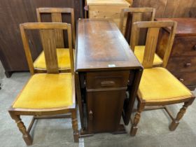 An oak drop-leaf table and four chairs