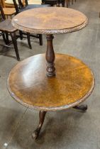 A Victorian burr walnut circular two tier dumb waiter