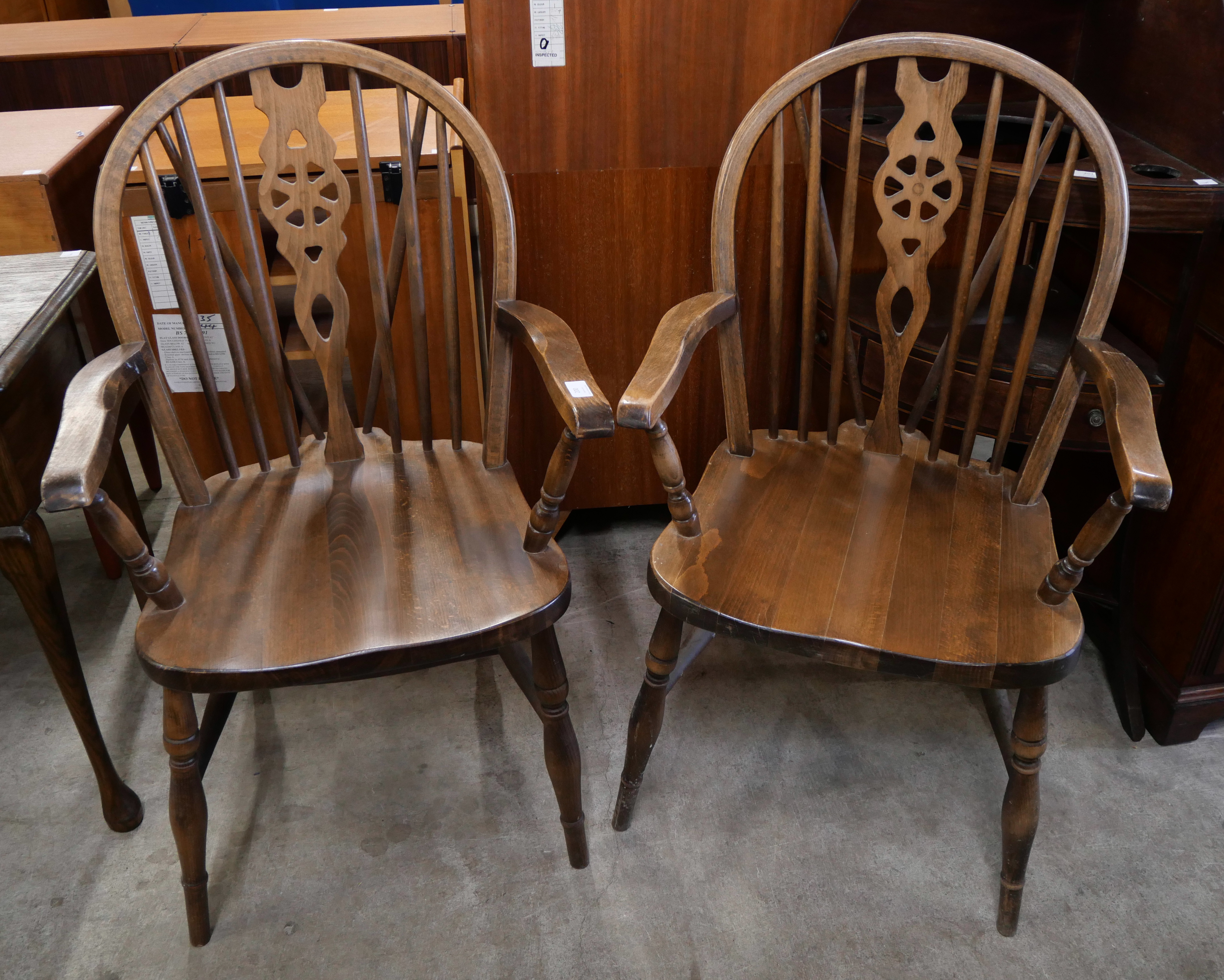 A pair of beech wheelback elbow chairs