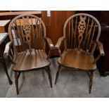 A pair of beech wheelback elbow chairs