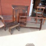 A George III oak wall hanging corner cupboard, a wall hanging shelf and an oak stool