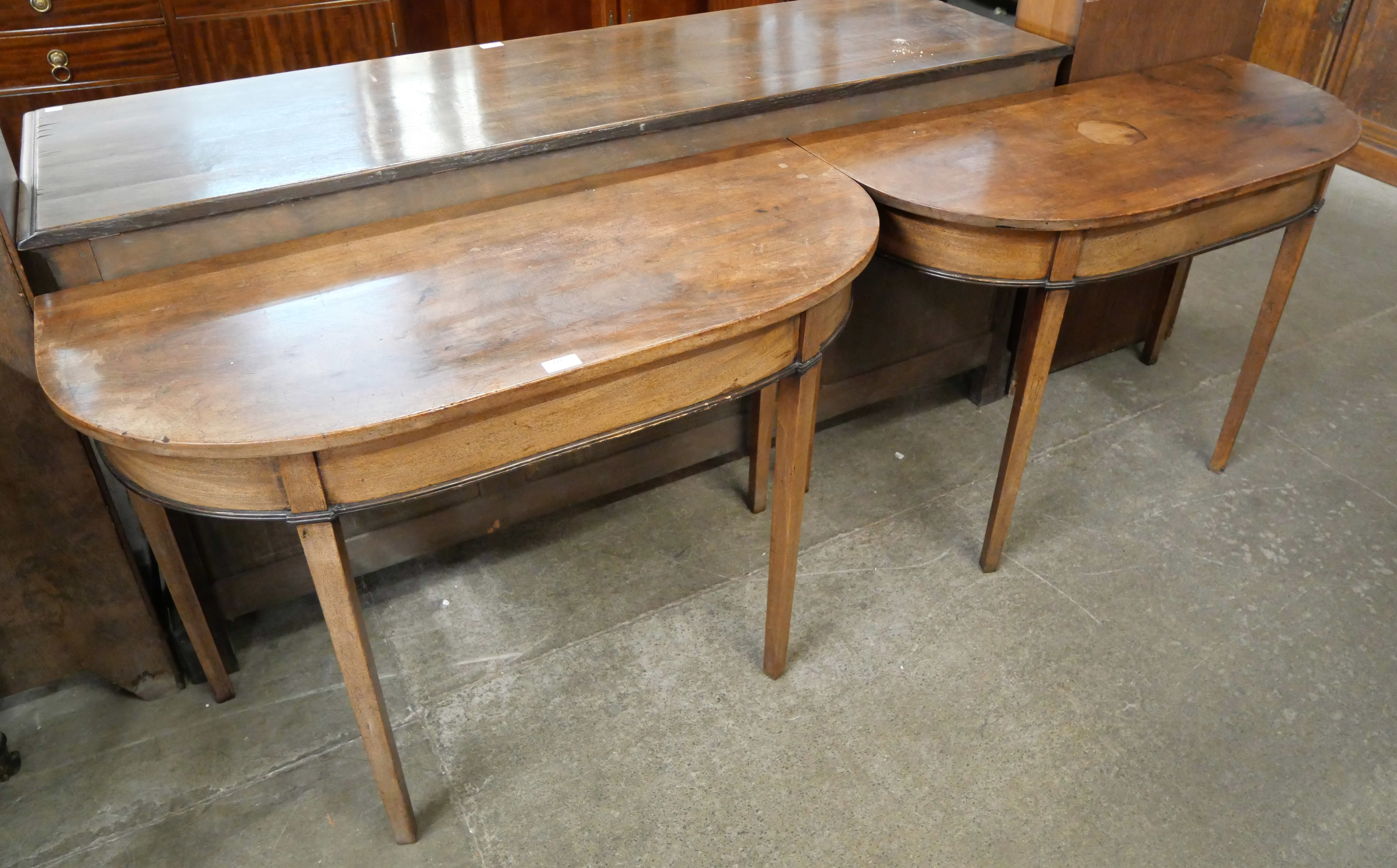 A pair of George IV mahogany D-shaped console tables