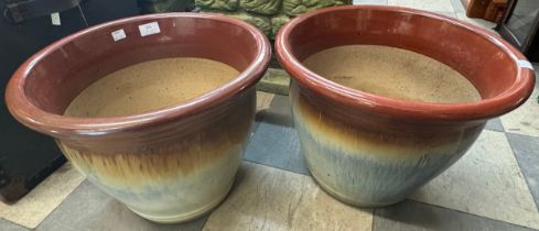 A pair of glazed terracotta garden plant pots