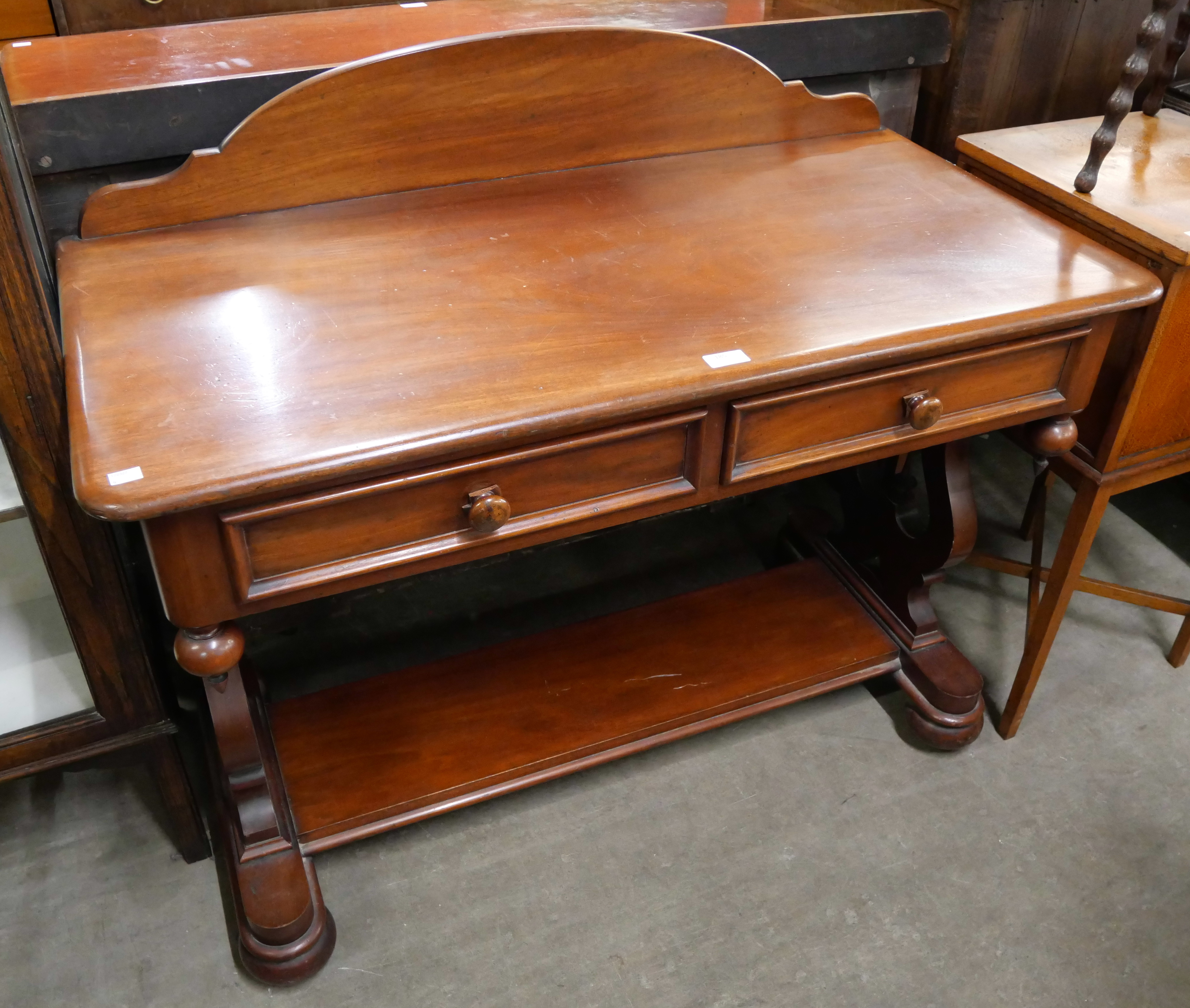 A Victorian mahogany two drawer side table