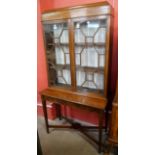 An Edward VII inlaid mahogany display cabinet on stand