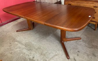 A Danish teak two leaf extending dining table
