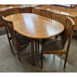 A Meredew teak extending dining table and four chairs