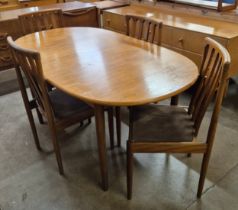 A Meredew teak extending dining table and four chairs