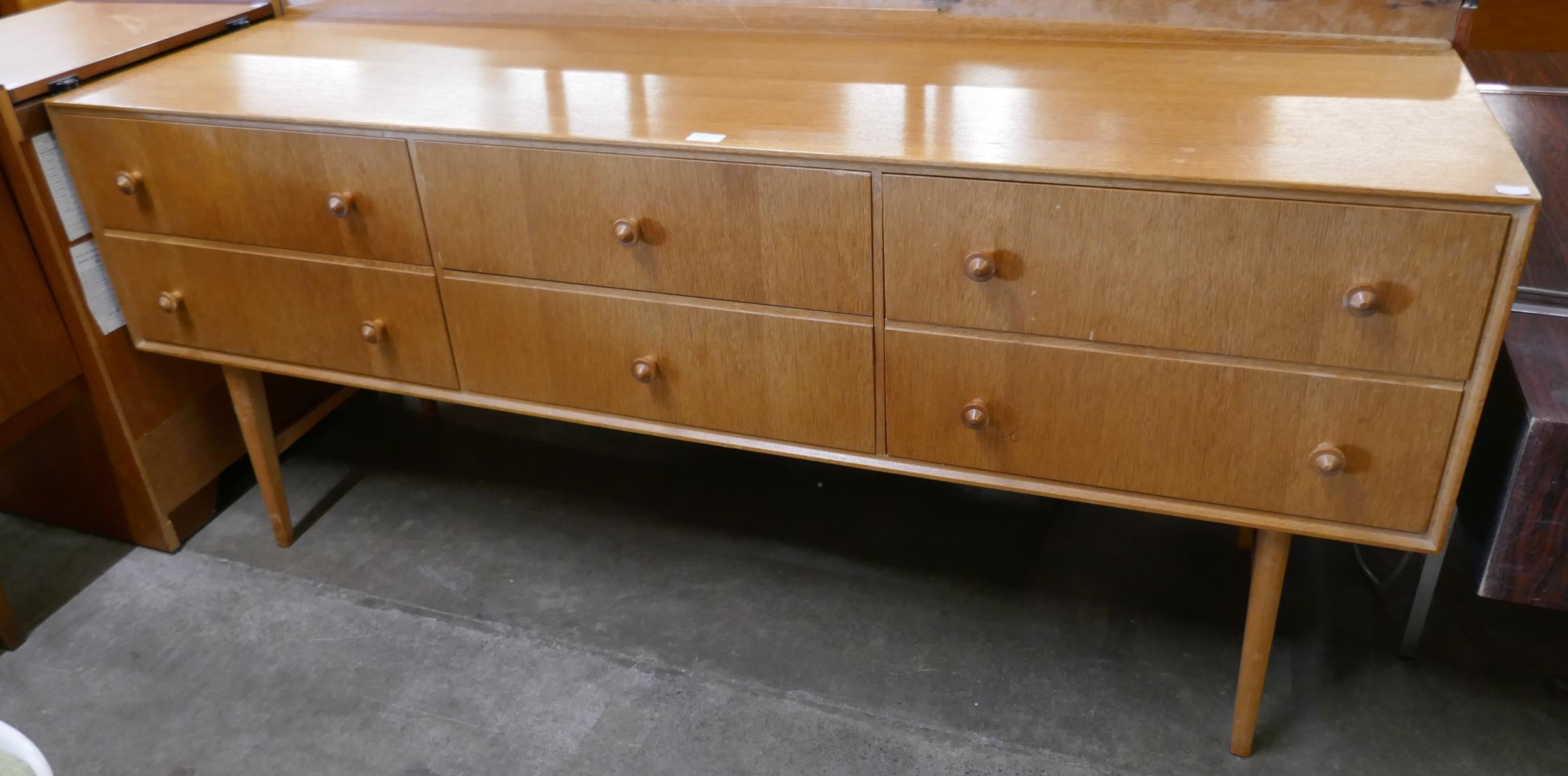 A teak sideboard, retailed by Heals