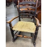 An 18th Century style elm rush seated rocking chair
