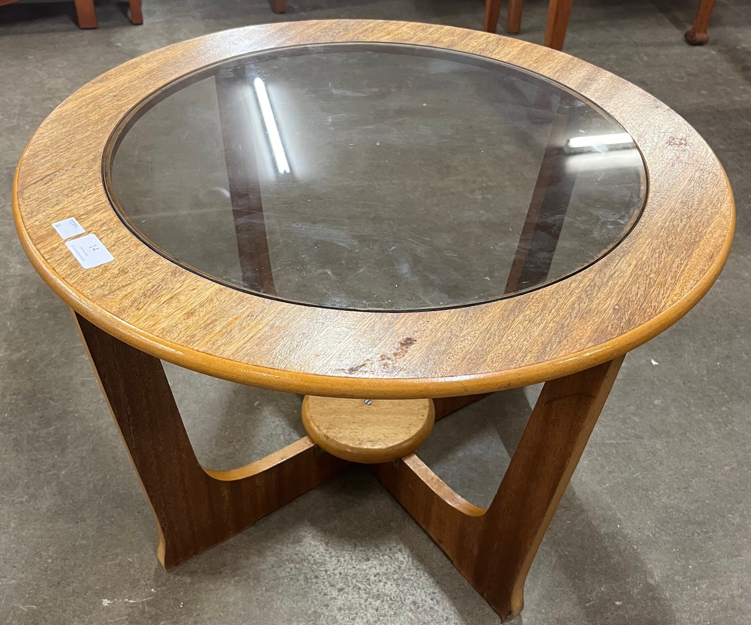 A teak and glass topped circular coffee table