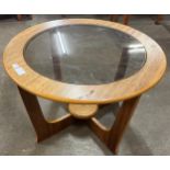 A teak and glass topped circular coffee table