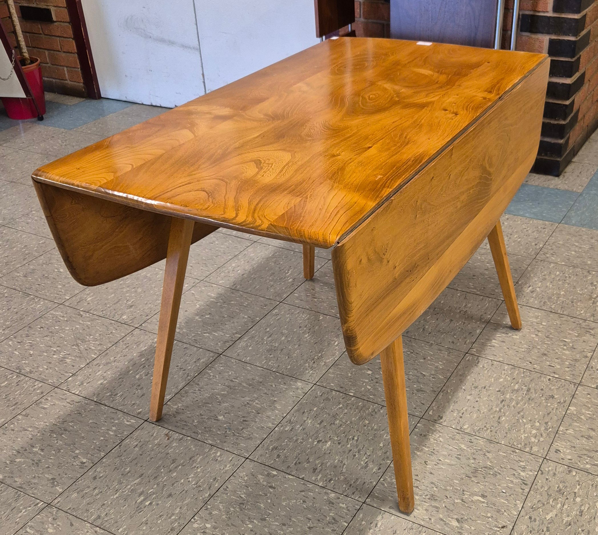 An Ercol Blonde elm and beech Windsor drop-leaf table