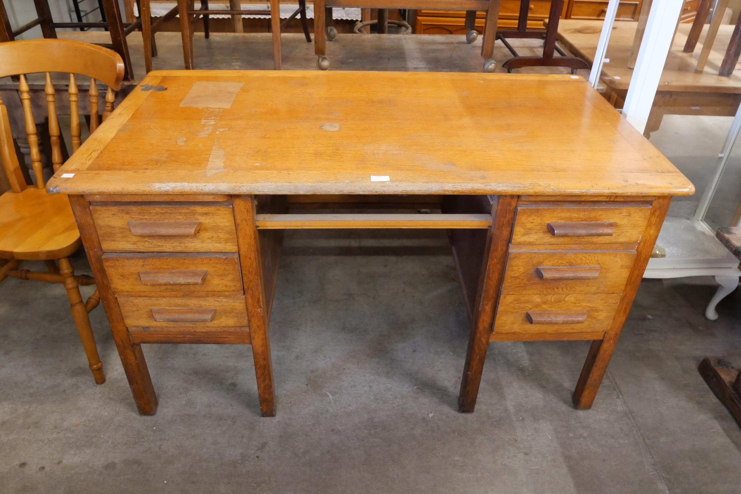 An oak desk and a painted display cabinet