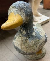 A concrete garden figure of a duck