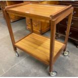 A teak and simulated rosewood cocktail trolley