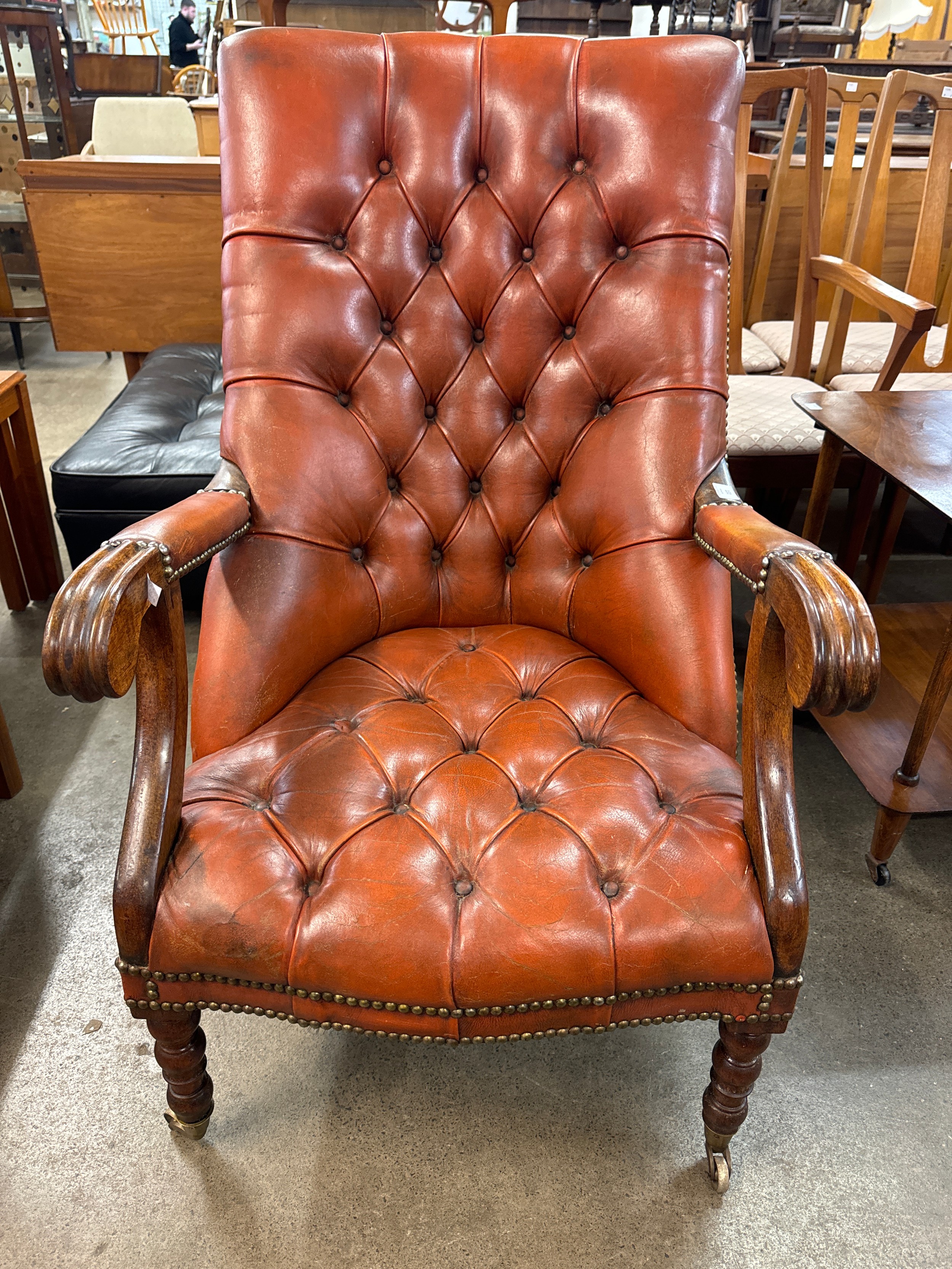 A Regency style mahogany and red leather open armchair