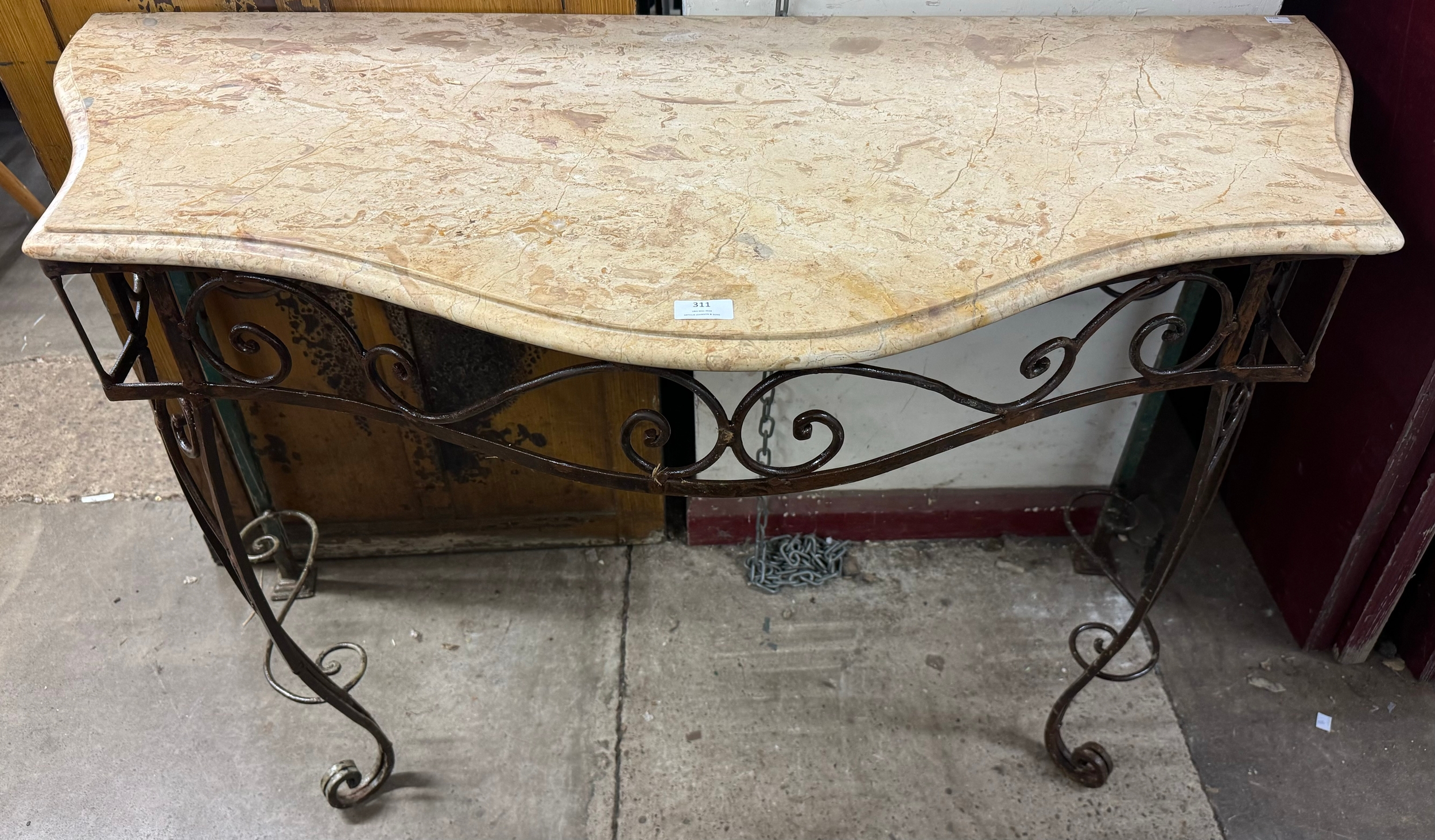 A French wrought iron and marble topped serpentine console table