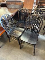 A set of four beech wheelback kitchen chairs