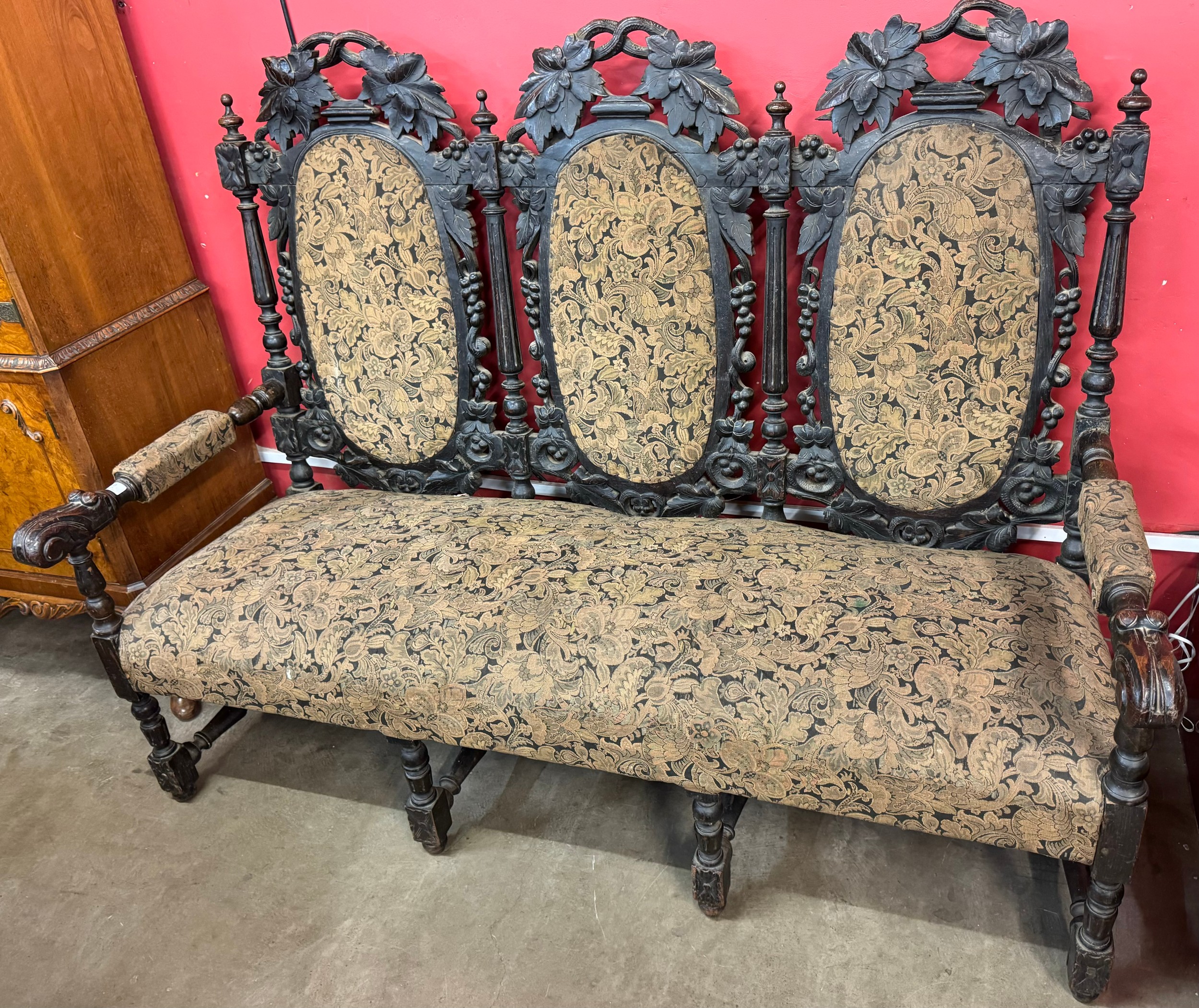 A Victorian Jacobean Revival carved oak settee/sofa