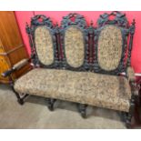 A Victorian Jacobean Revival carved oak settee/sofa