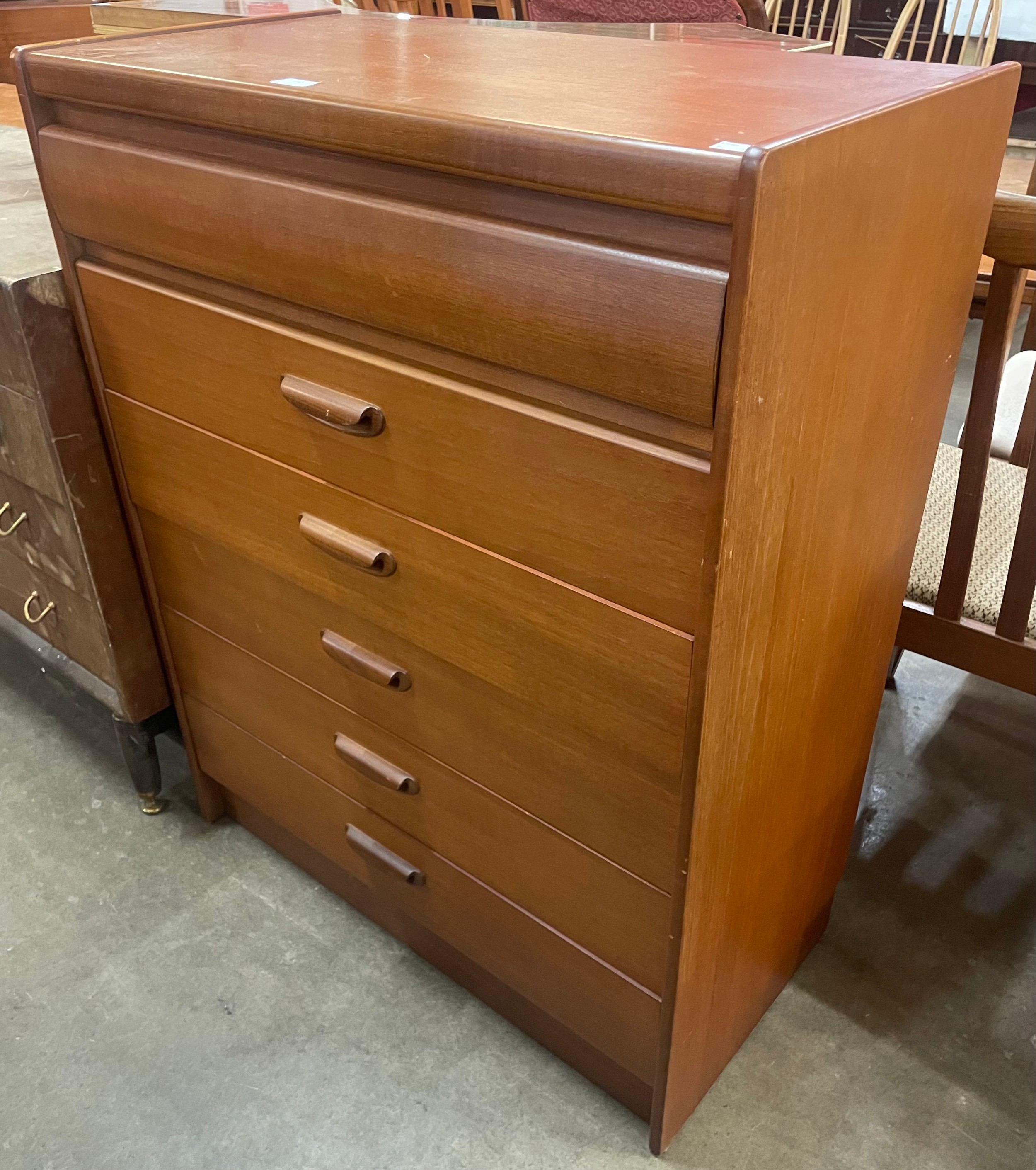 A teak chest of drawers