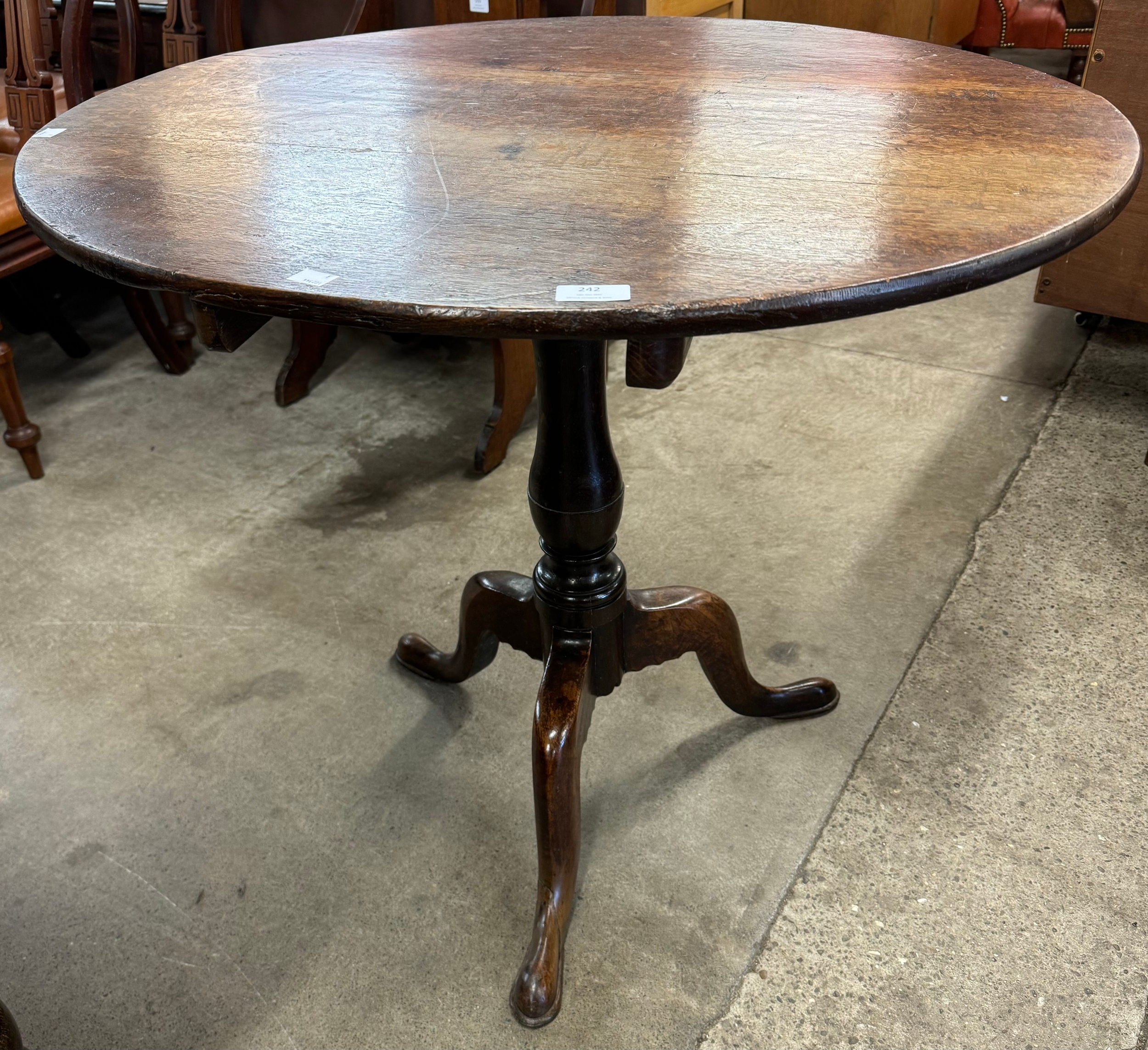 A George III oak circular tilt-top tripod tea table