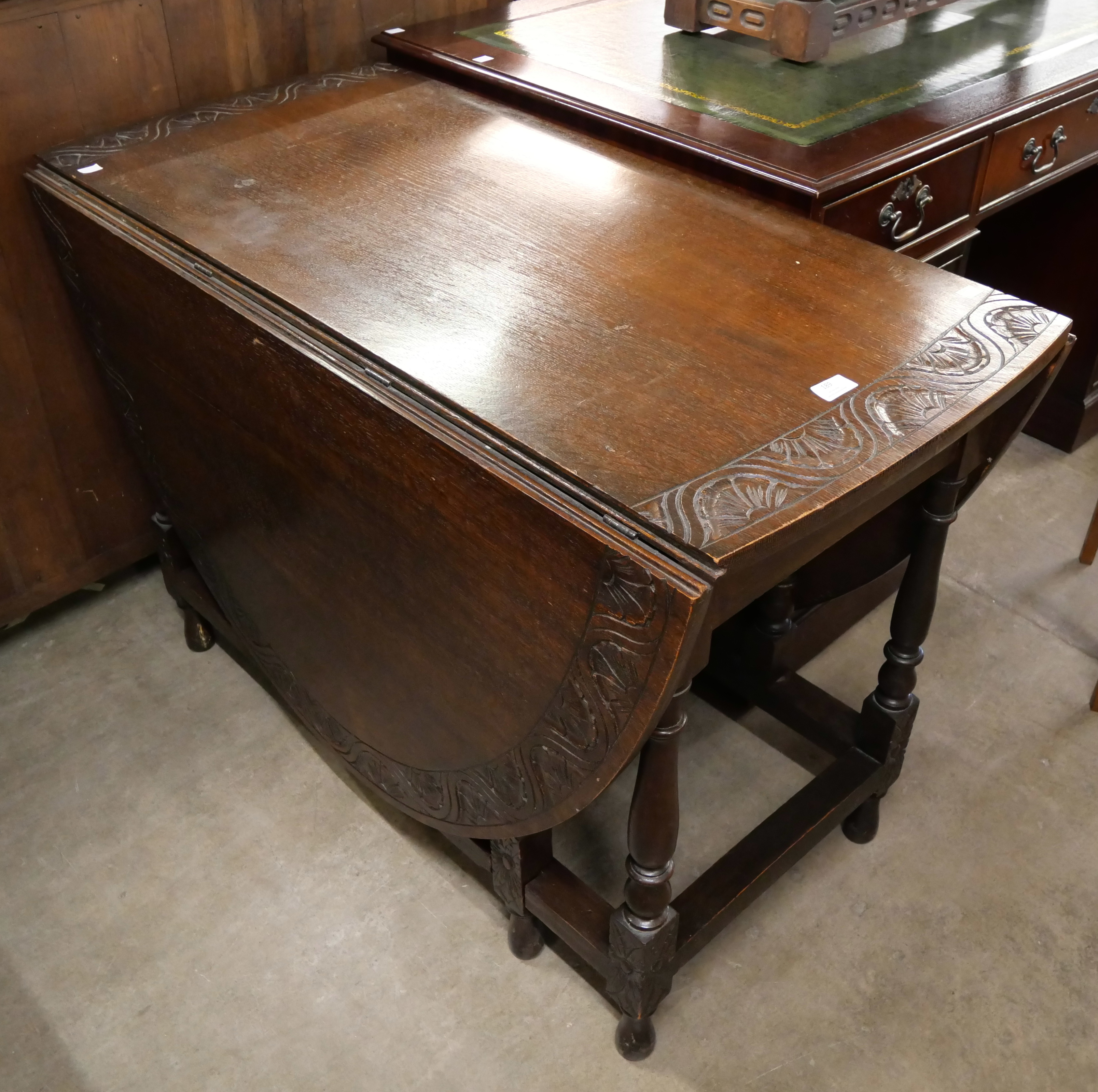 An early 20th Century carved oak gateleg table