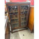 An Edward VII mahogany and stained glass two door bookcase