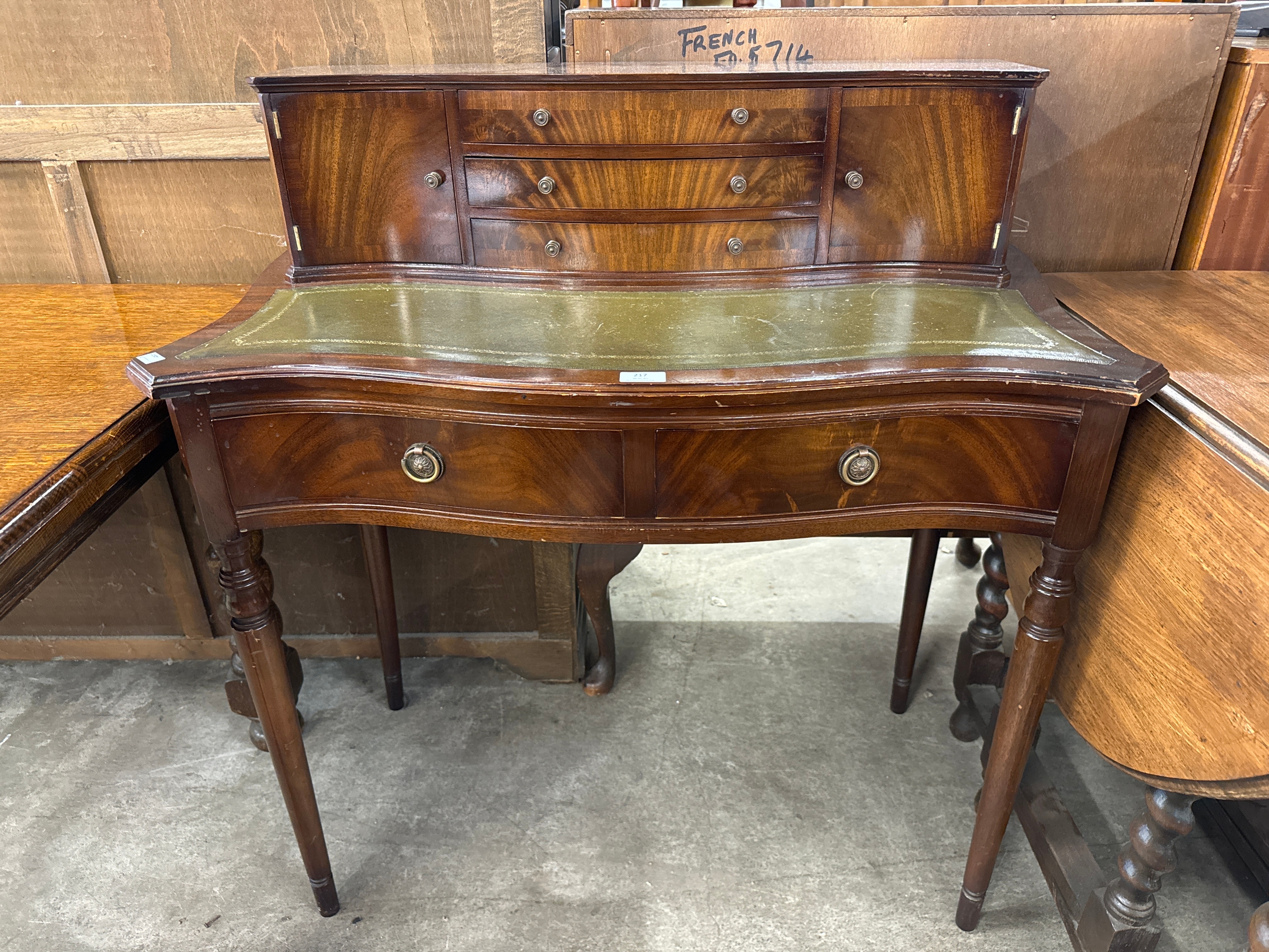 A Regency style mahogany and green leather topped bonheur de jour