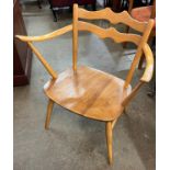 An Ercol Blonde elm and beech 493 model elbow chair